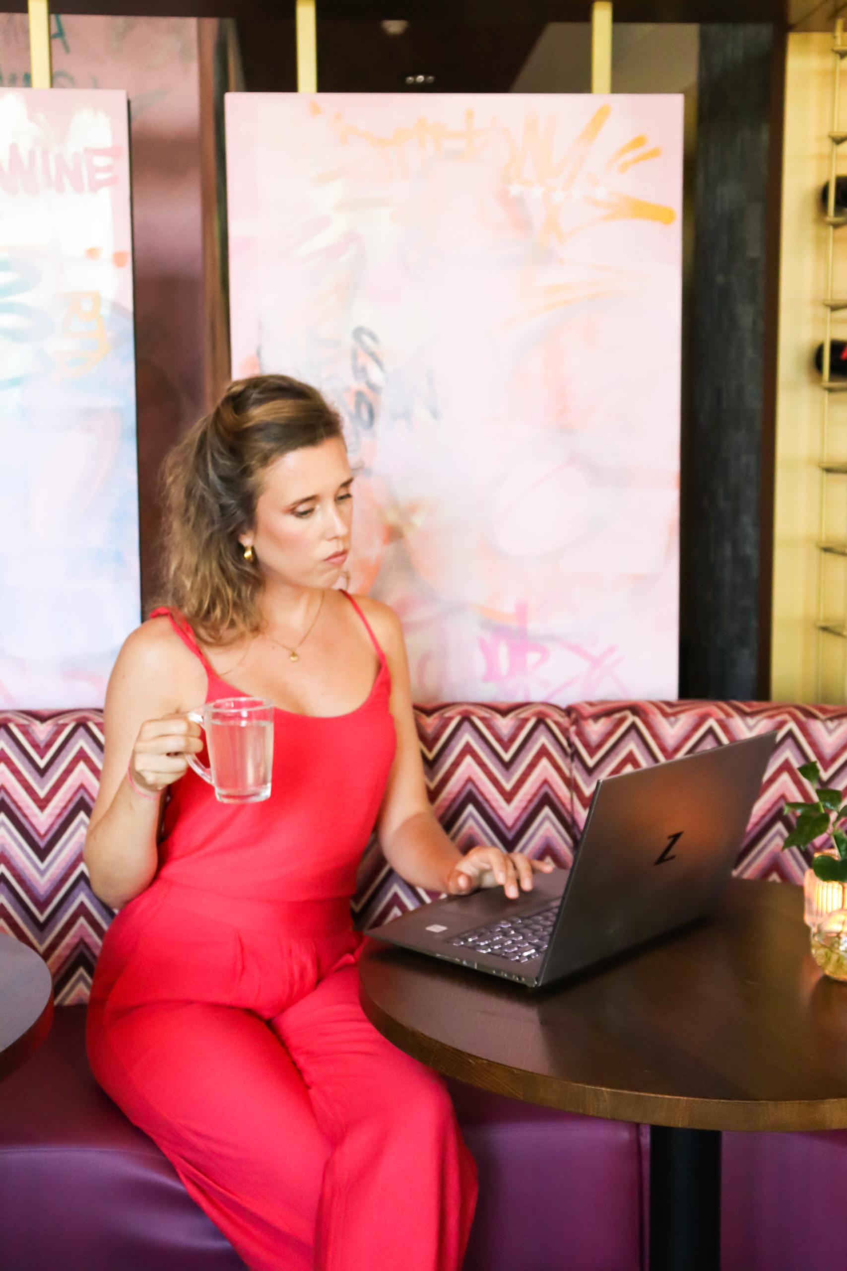 Luciënne Bregman, somatic money block coach, in a tropical landscape